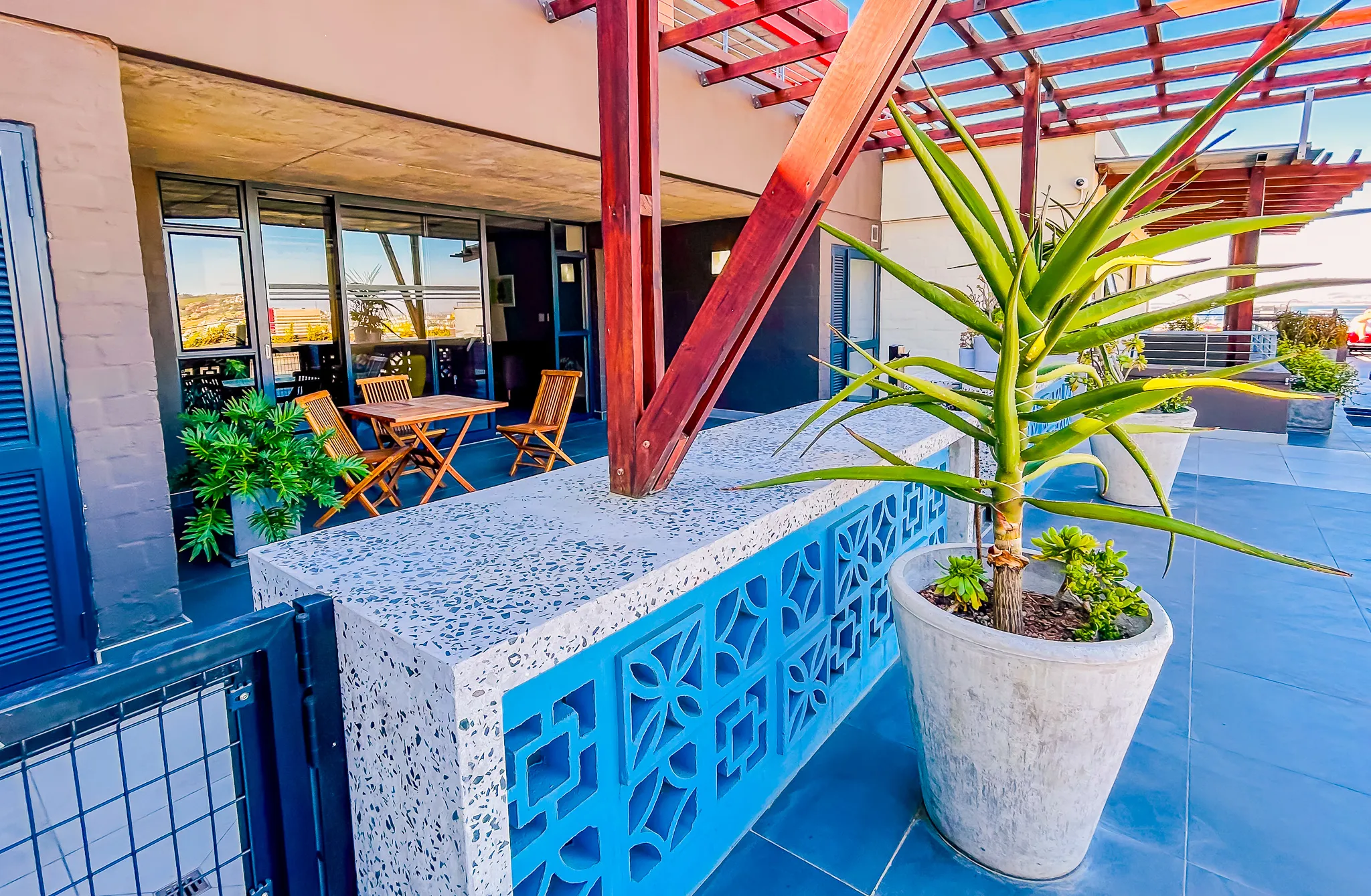 Rooftop terrace with seating and aloe plants